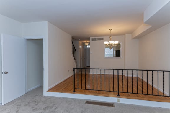 an empty living room with a staircase and a wooden floor at Indian Creek Apartments*, Cincinnati, OH
