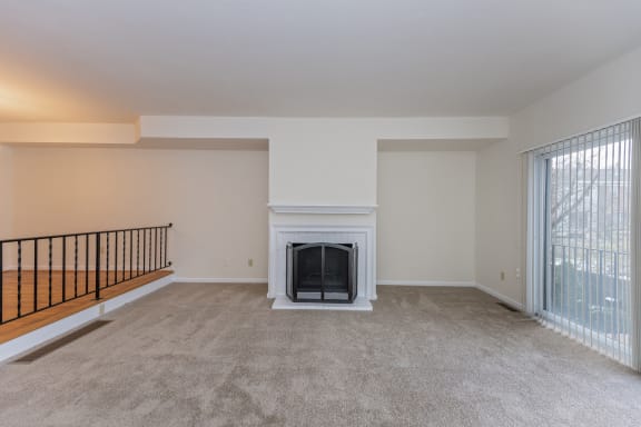 an empty living room with a fireplace and a window at Indian Creek Apartments, Cincinnati, OH, 45236