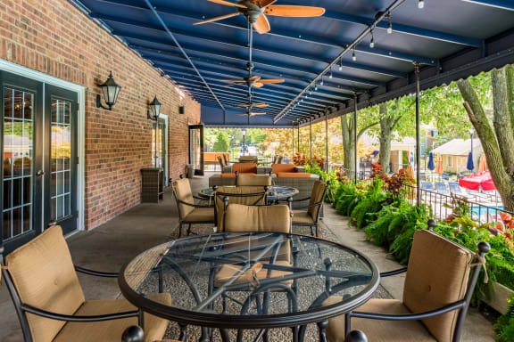 a patio with tables and chairs and a blue ceiling at Indian Creek Apartments*, Ohio
