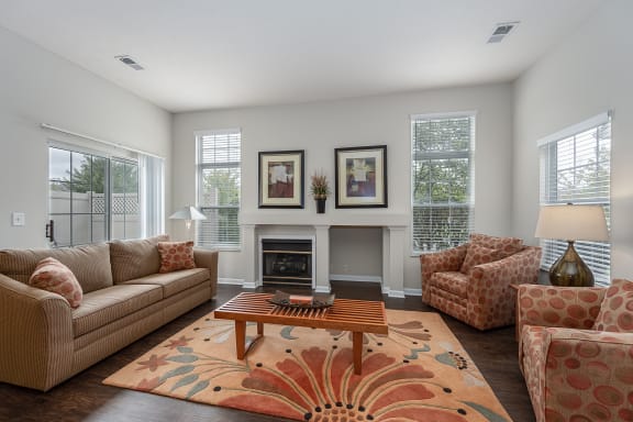 Living room with couches and chairs and a fireplace