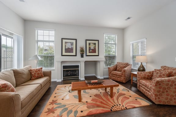 Living room with couches and chairs and a fireplace