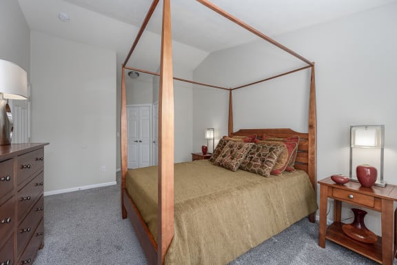 Bedroom with a canopy bed and a dresser