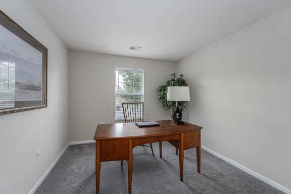 Office with a desk and a chair and a window