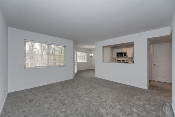 an empty living room with a large window and a kitchen at Ivy Hills Living Spaces, Ohio, 45244