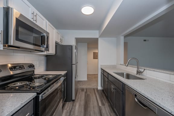 an empty kitchen with granite counter tops and stainless steel appliances at Ivy Hills Living Spaces, Cincinnati, 45244