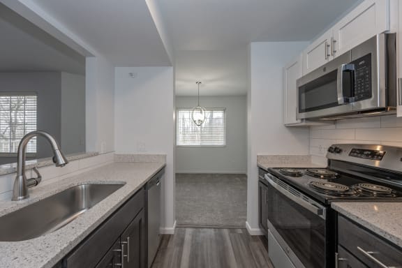 an empty kitchen with granite counter tops and stainless steel appliances at Ivy Hills Living Spaces, Cincinnati, 45244