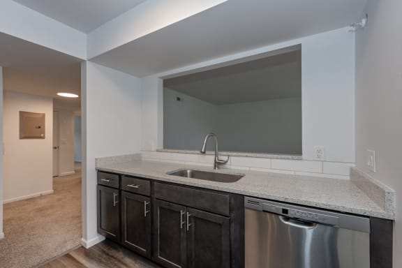 an empty kitchen with a sink and a large mirror at Ivy Hills Living Spaces, Cincinnati