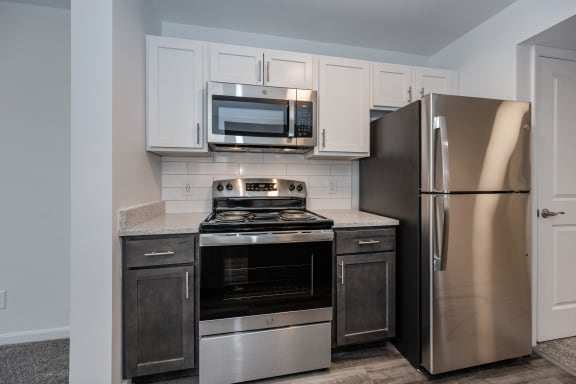 an updated kitchen with stainless steel appliances and white cabinets at Ivy Hills Living Spaces, Ohio, 45244