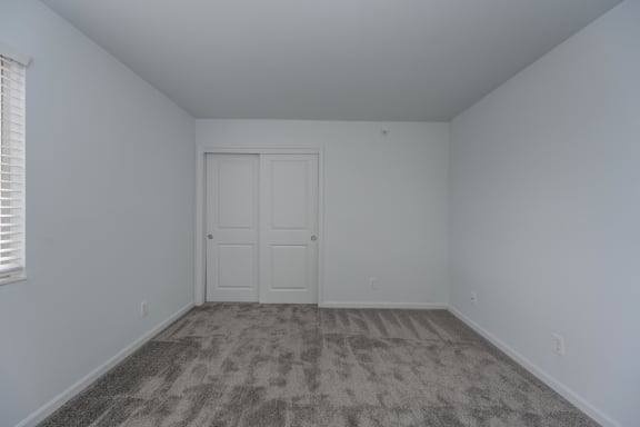 an empty room with carpet and a white door at Ivy Hills Living Spaces, Cincinnati, OH, 45244