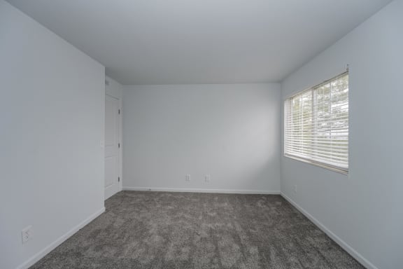 an empty room with carpet and a window at Ivy Hills Living Spaces, Cincinnati, Ohio