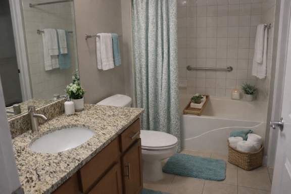 A bathroom with a sink, toilet, and bathtub.