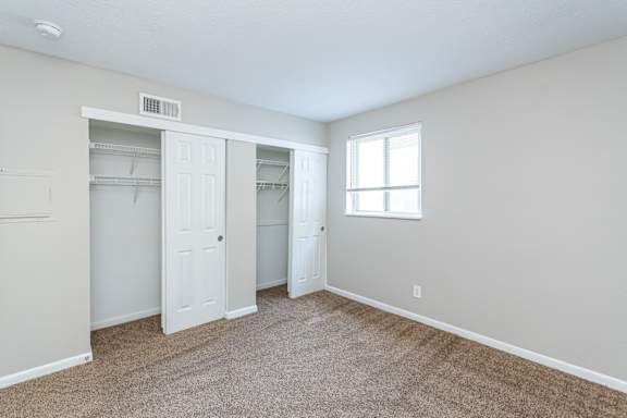 Spacious bedroom with carpeted floor at Trails at Mariemont, Cincinnati, Ohio