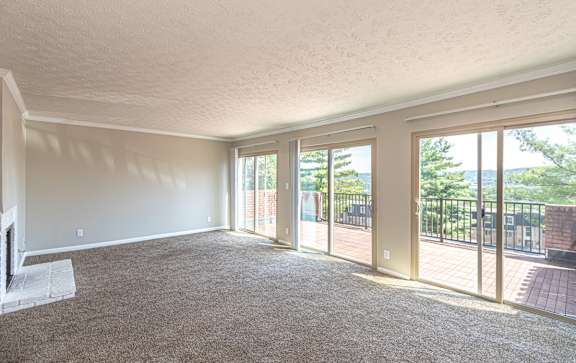 Living room with attached balcony at Trails at Mariemont, Ohio, 45227