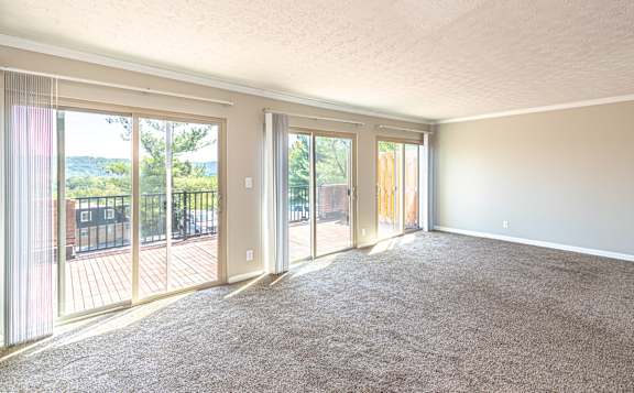 Living room with sliding glass door at Trails at Mariemont, Cincinnati, OH