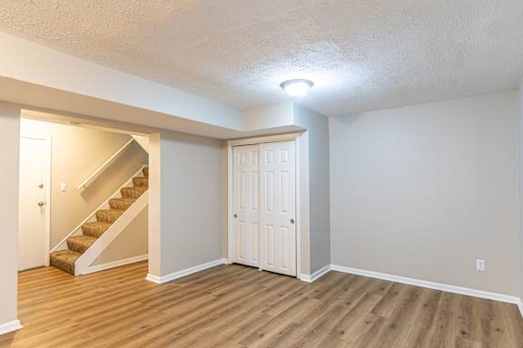 Living room with staircase beside at Trails at Mariemont, Ohio