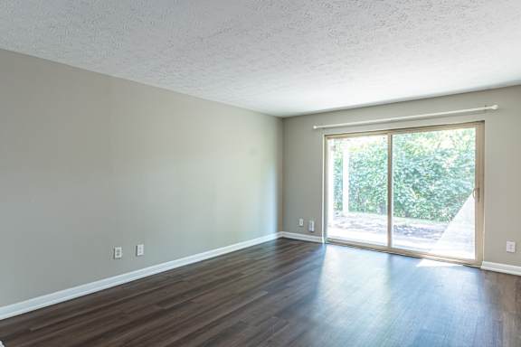 Living room with sliding glass door at Trails at Mariemont, Cincinnati, 45227