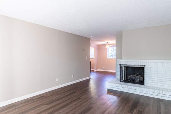 Living room with fireplace and wooden floor at Trails at Mariemont, Cincinnati