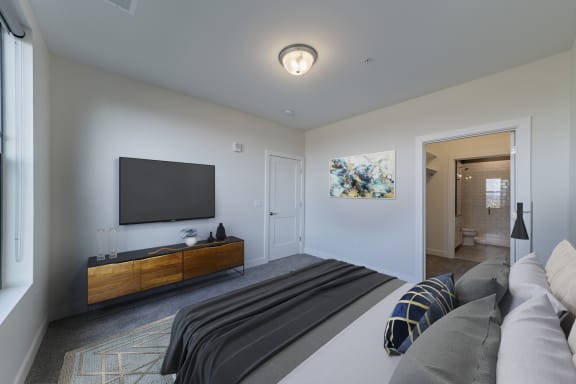a master bedroom with a tv and a couch at Adams Edge Apartments, Cincinnati, 45202