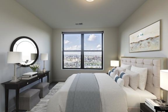 a master bedroom with a large bed and a window at Adams Edge Apartments, Cincinnati, Ohio
