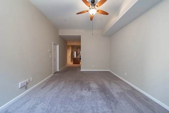 Spacious carpeted living room with vaulted ceiling at Renaissance at the Power Building Apartments, Cincinnati