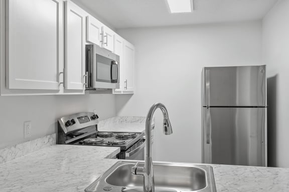 a kitchen with a sink and a refrigerator