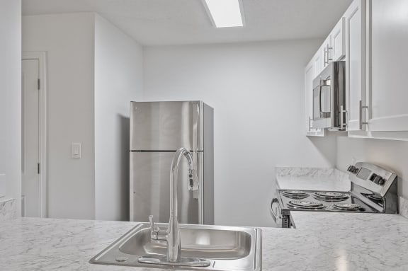 a kitchen with a sink and a refrigerator