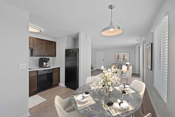 A modern dining room with a black granite table and white chairs.