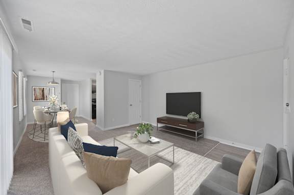 A living room with a white couch and a television.