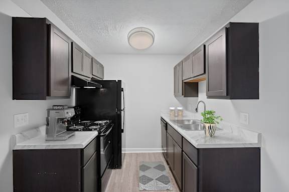 A kitchen with black appliances and cabinets. at The Apex, Ohio, 45239