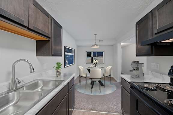 A modern kitchen with a dining table  at The Apex, Cincinnati, OH