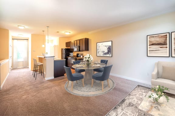 a living room with a dining room table and a kitchen  at Grove City Summit, Grove City, Ohio