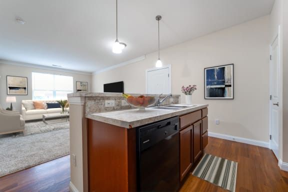 a kitchen with an island and a living room with a couch  at Grove City Summit, Grove City