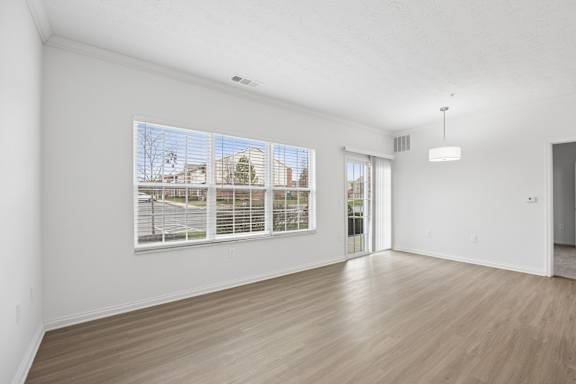 A room with a large window and a sliding glass door.