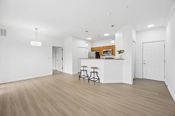A kitchen with a bar stool and a countertop.