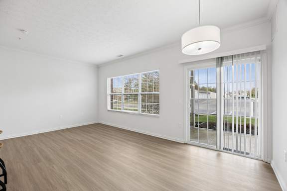 A room with a sliding glass door leading to a balcony.