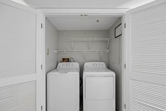 A small laundry room with a washer and dryer.