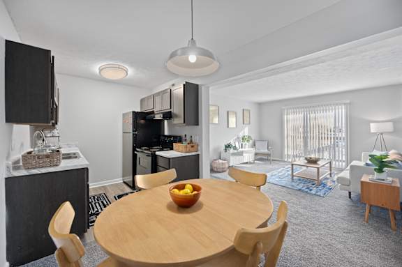A modern kitchen with a dining table and chairs.