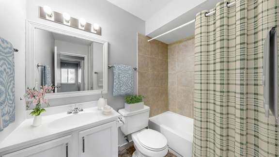 A bathroom with a white sink and a white toilet.