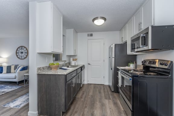 an open kitchen with black appliances and white cabinets