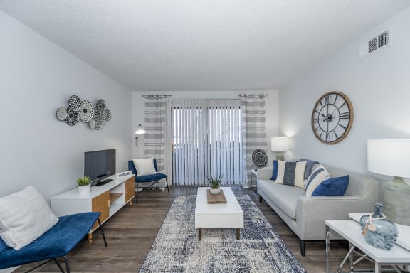 our apartments offer a living room with a couch and a tv