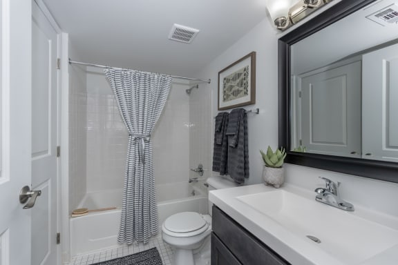 a bathroom with a shower and a sink and a toilet