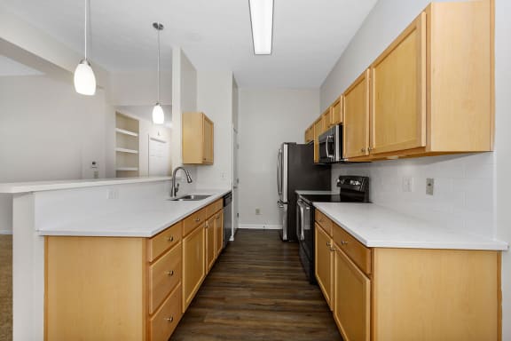 a kitchen with wooden cabinets and a black refrigerator at Bishops Gate, Cincinnati, OH, 45249