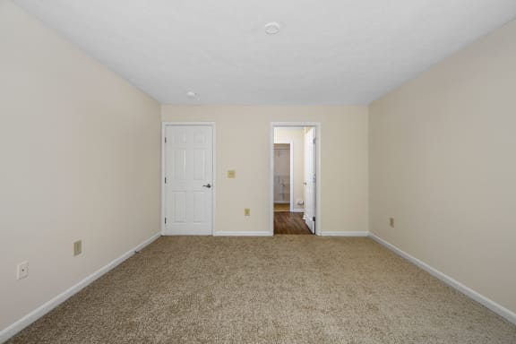 an empty living room with carpet and a door to a hallway at Bishops Gate, Cincinnati, OH, 45249