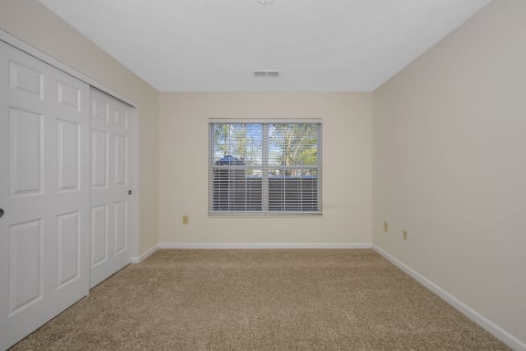 an empty bedroom with a window and a closet at Bishops Gate, Cincinnati, OH