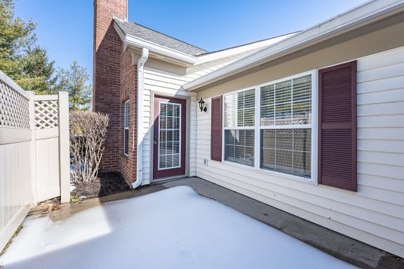 the front porch of a home with a white driveway and a red door at Bishops Gate, Ohio