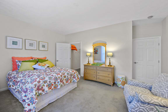 a bedroom with a bed and a dresser with a mirror at Bishops Gate, Cincinnati