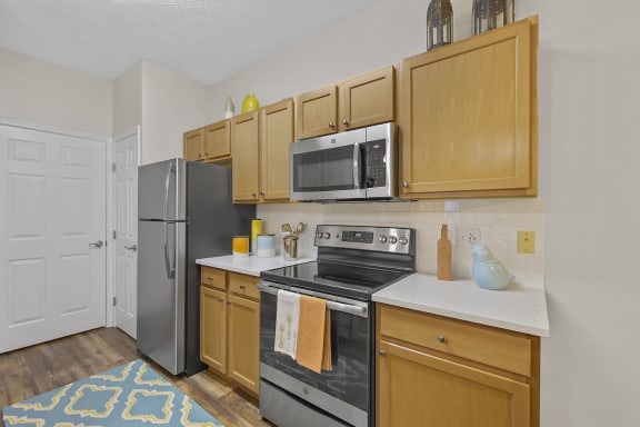 a kitchen with stainless steel appliances and wooden cabinets at Bishops Gate, Ohio, 45249