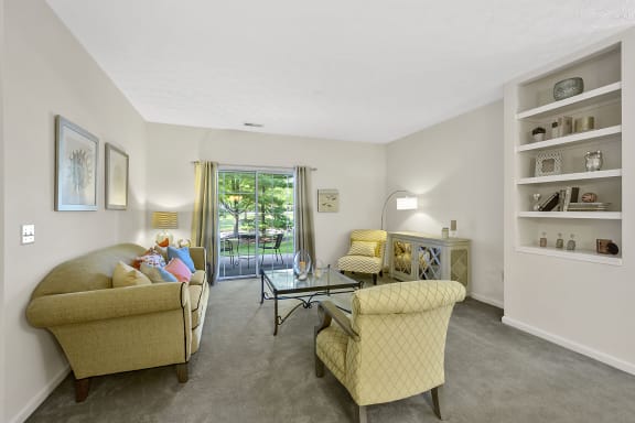 a living room with couches and chairs and a glass table at Bishops Gate, Cincinnati