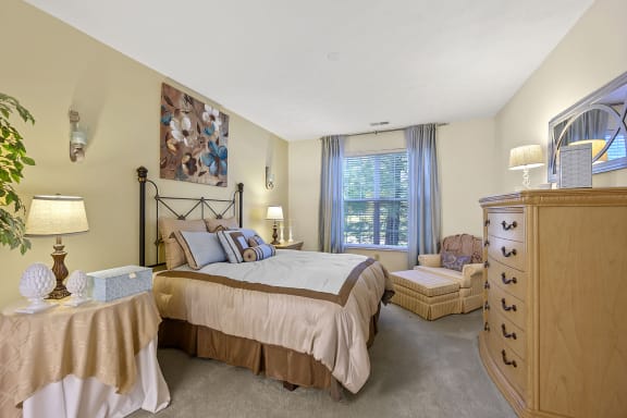 a bedroom with a bed and a chair and a dresser at Bishops Gate, Ohio, 45249