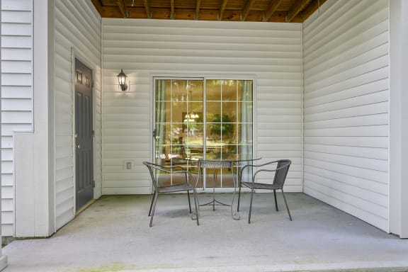 a dining table in a room with white walls and a glass door at Bishops Gate, Cincinnati, OH